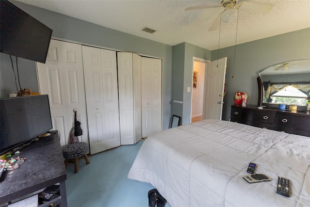 bedroom with a closet, ceiling fan, carpet, and a textured ceiling