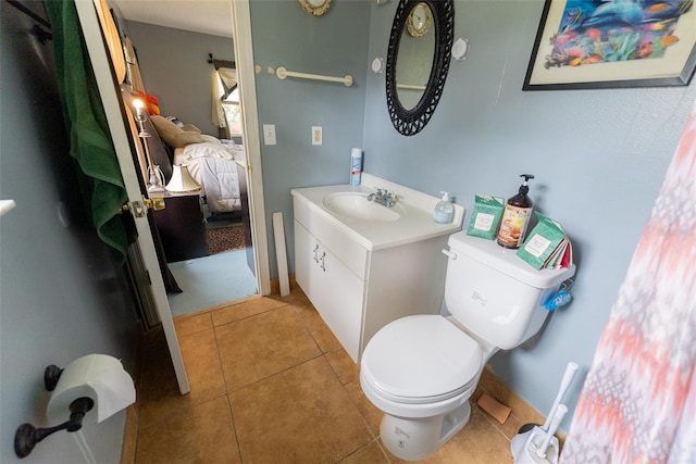 bathroom featuring vanity, tile floors, and toilet