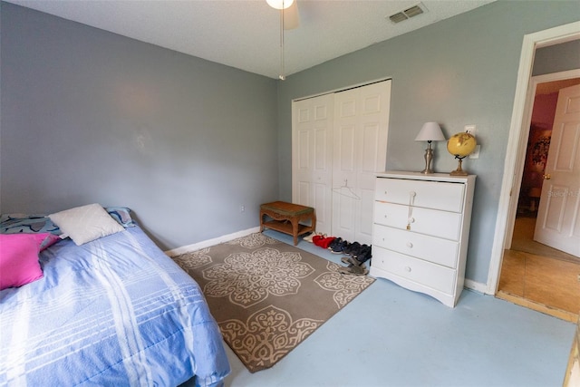 bedroom featuring a closet, ceiling fan, and tile floors