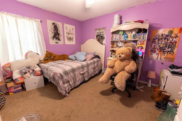 carpeted bedroom featuring a textured ceiling and ceiling fan