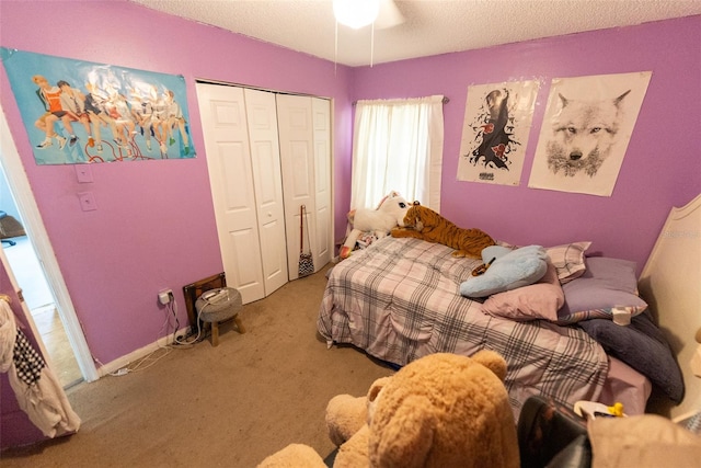 carpeted bedroom featuring a closet, a textured ceiling, and ceiling fan