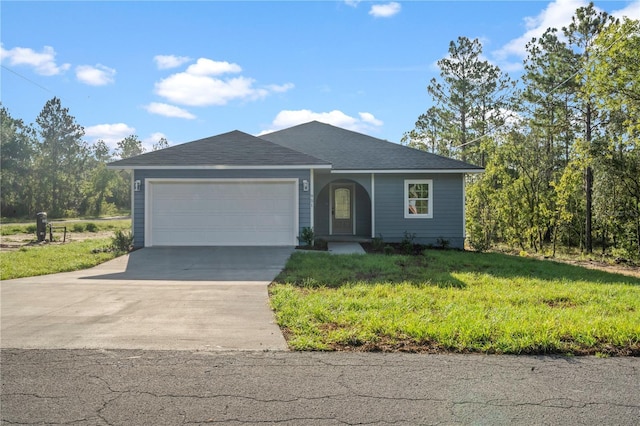 ranch-style house featuring a garage and a front lawn