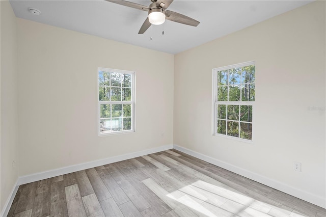 spare room with ceiling fan and light hardwood / wood-style flooring