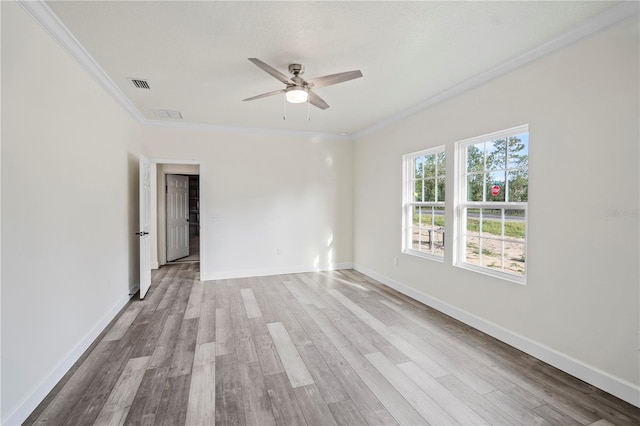 unfurnished room featuring light hardwood / wood-style floors, ceiling fan, and crown molding