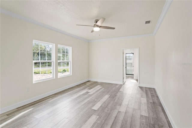 empty room featuring crown molding, ceiling fan, light hardwood / wood-style floors, and a textured ceiling