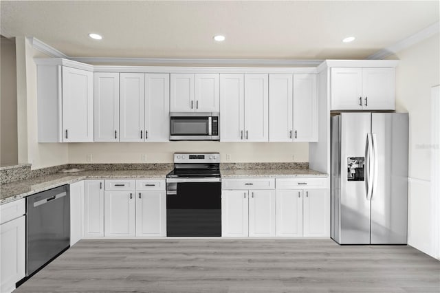 kitchen featuring white cabinets, crown molding, and stainless steel appliances