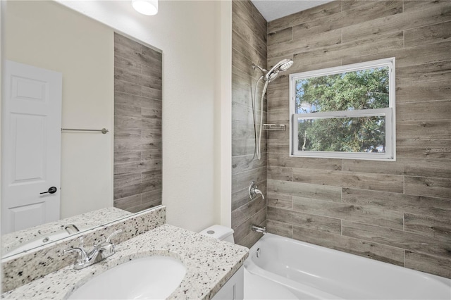 full bathroom featuring vanity, toilet, and tiled shower / bath combo