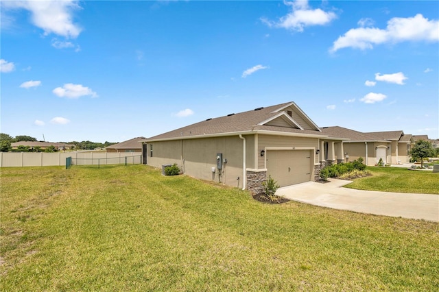 view of side of home featuring a lawn and a garage