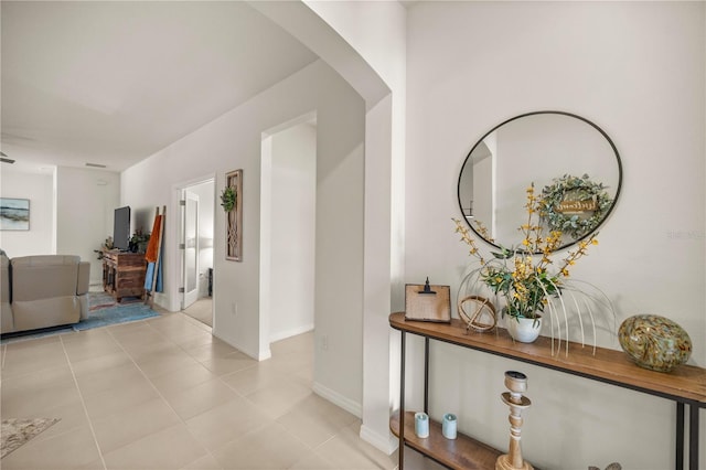 corridor featuring light tile patterned floors