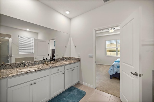 bathroom featuring tile patterned floors, vanity, and a shower with shower door