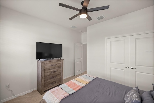 carpeted bedroom featuring ceiling fan and a closet