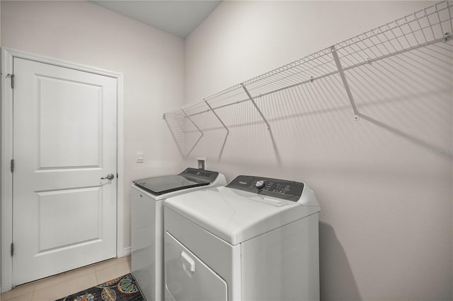 washroom featuring light tile patterned floors and washer and dryer