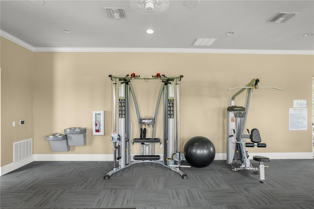 exercise room featuring crown molding