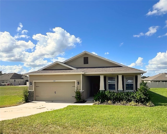 view of front of home with a garage and a front lawn