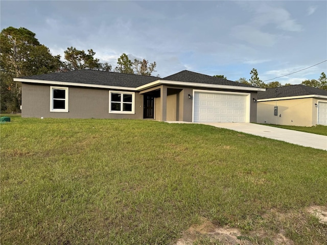 ranch-style house with a garage and a front lawn