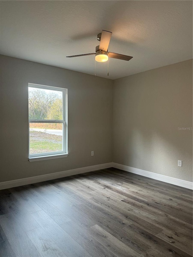 empty room featuring hardwood / wood-style floors and ceiling fan