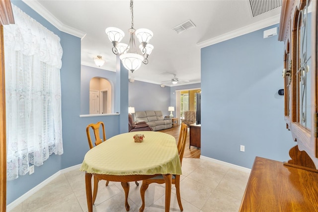 tiled dining space with ceiling fan with notable chandelier and ornamental molding