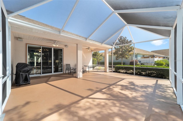 unfurnished sunroom featuring ceiling fan