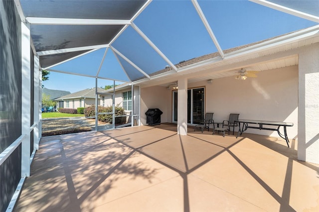 unfurnished sunroom with ceiling fan