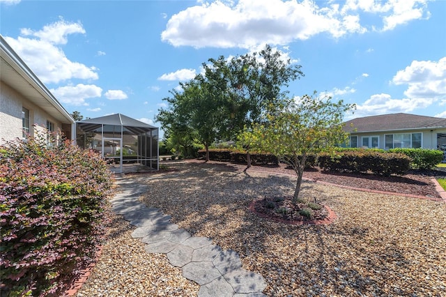 view of yard with glass enclosure