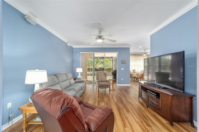 living room featuring ceiling fan, light hardwood / wood-style floors, and ornamental molding