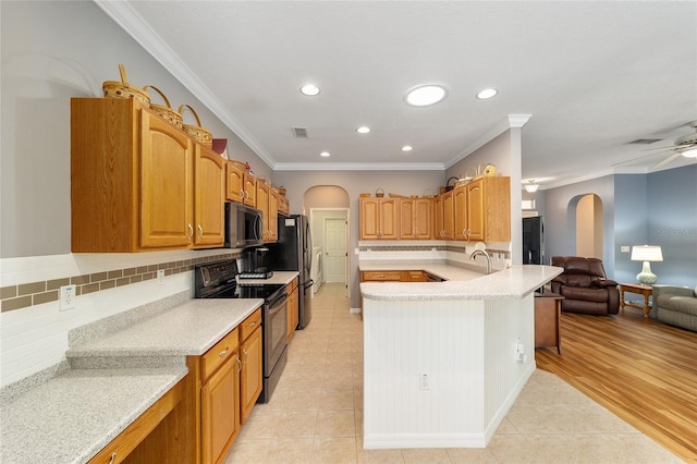 kitchen featuring ceiling fan, stainless steel appliances, crown molding, and light tile floors