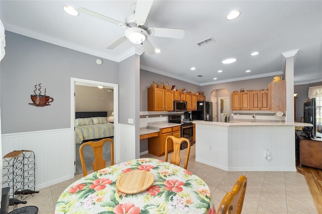 dining space with ornamental molding, ceiling fan, and light tile floors