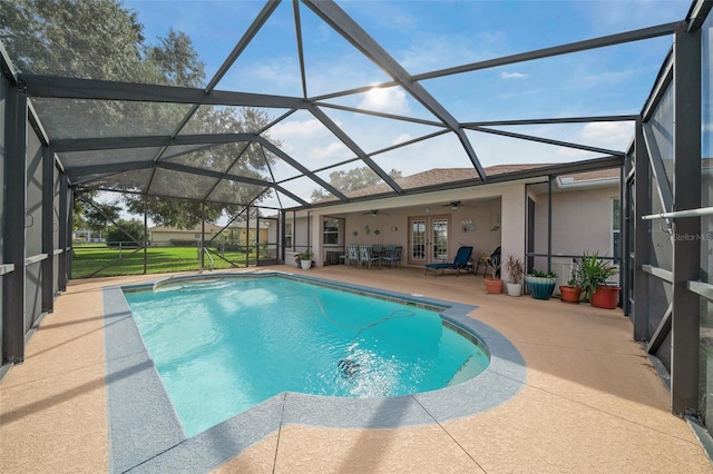 view of pool featuring french doors, a patio, ceiling fan, and a lanai