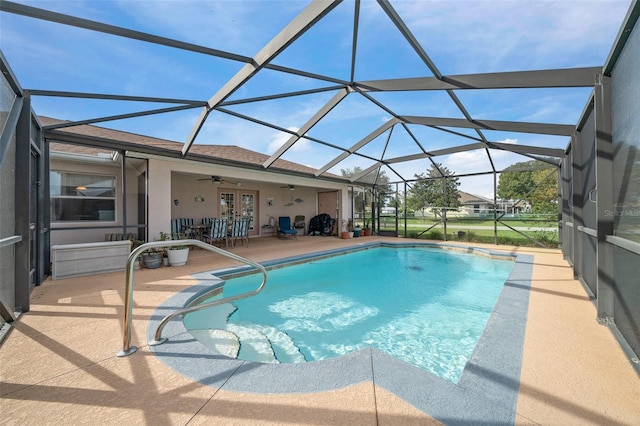 view of pool featuring french doors, glass enclosure, ceiling fan, and a patio area