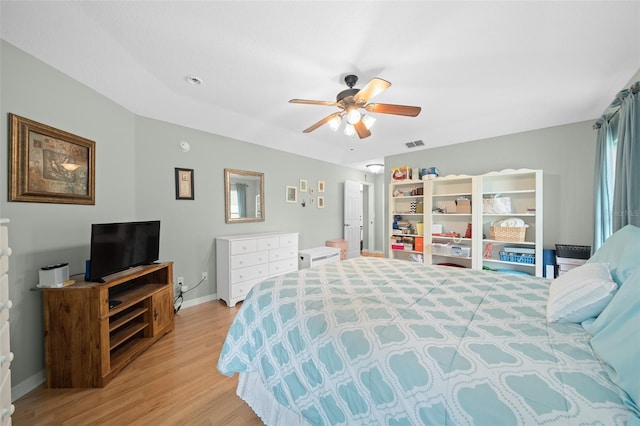 bedroom with ceiling fan and light hardwood / wood-style flooring