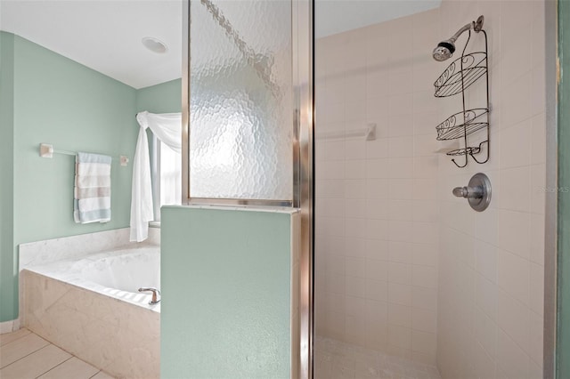 bathroom featuring tile patterned floors and shower with separate bathtub