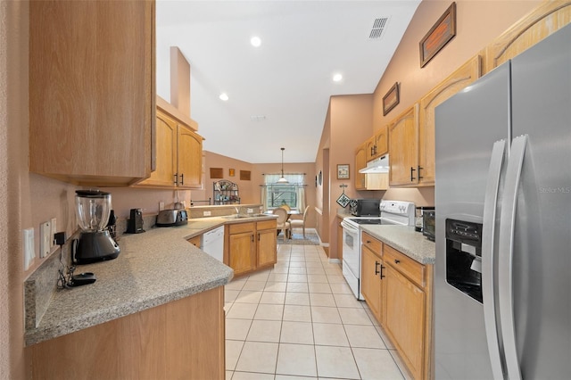 kitchen with pendant lighting, white appliances, vaulted ceiling, light tile patterned floors, and kitchen peninsula