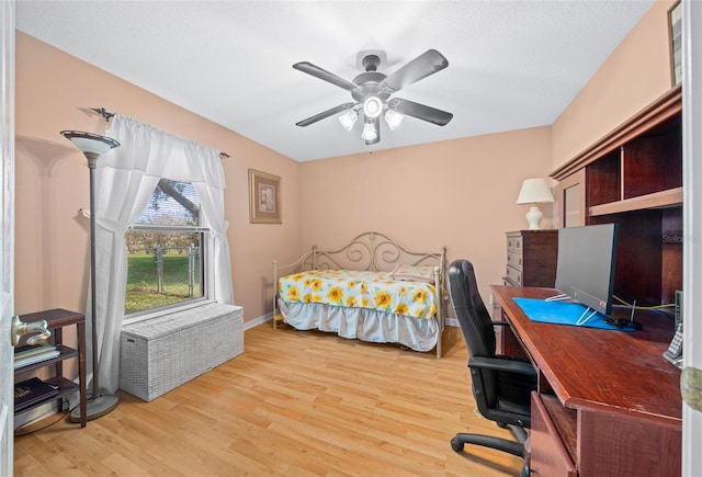 bedroom with ceiling fan and light hardwood / wood-style flooring