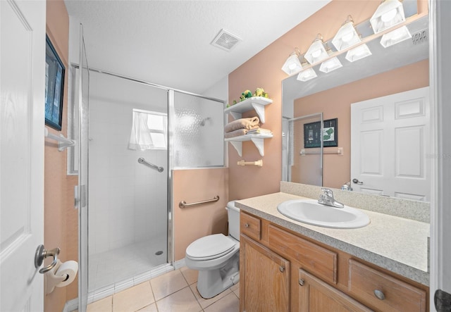 bathroom featuring walk in shower, tile patterned flooring, vanity, and toilet