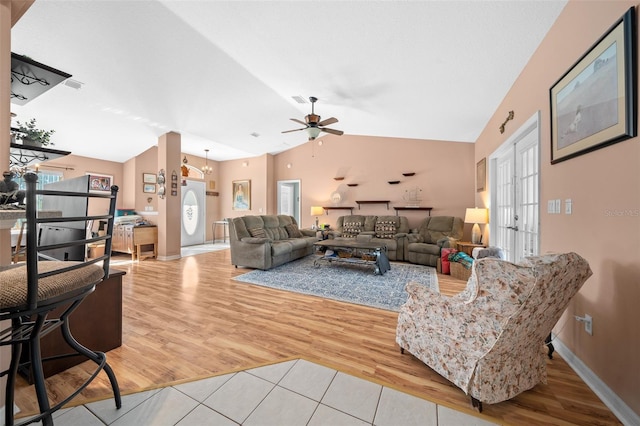 living room with ceiling fan, high vaulted ceiling, and light hardwood / wood-style flooring