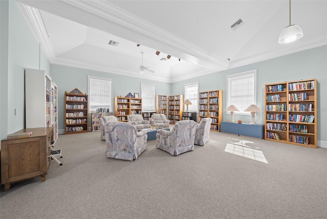 unfurnished living room featuring ceiling fan, ornamental molding, and light carpet