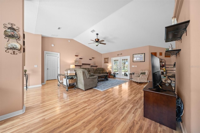 living room featuring ceiling fan, light wood-type flooring, high vaulted ceiling, and french doors