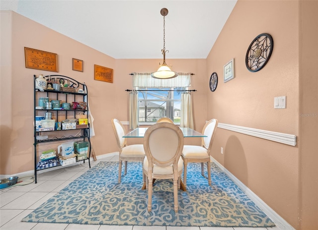 dining area with light tile patterned floors and lofted ceiling