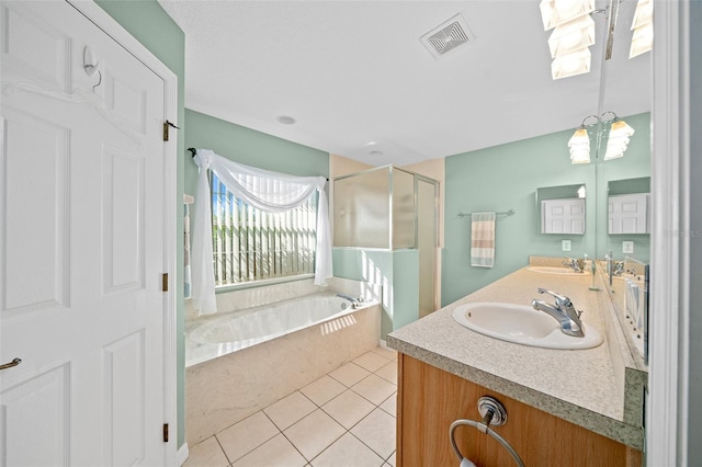 bathroom featuring tile patterned floors, vanity, plus walk in shower, and a chandelier