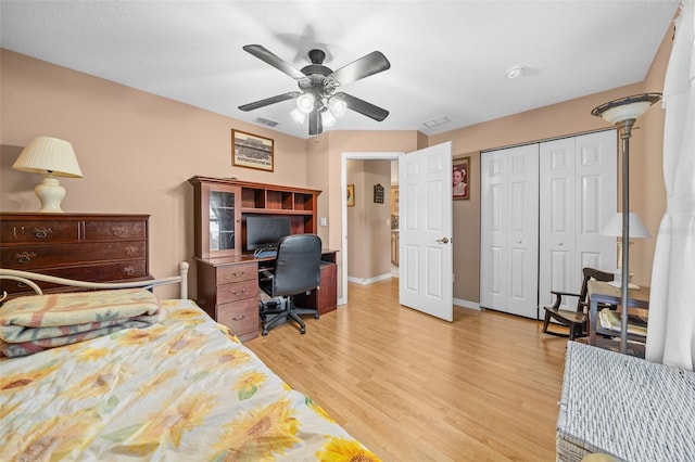 bedroom with ceiling fan, a closet, and light hardwood / wood-style floors