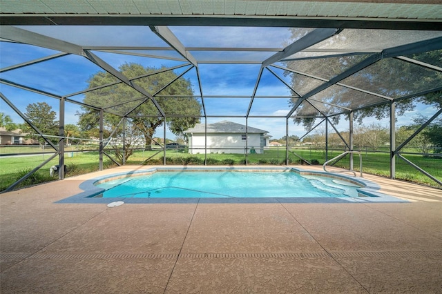 view of swimming pool with a lanai, a patio area, and a yard