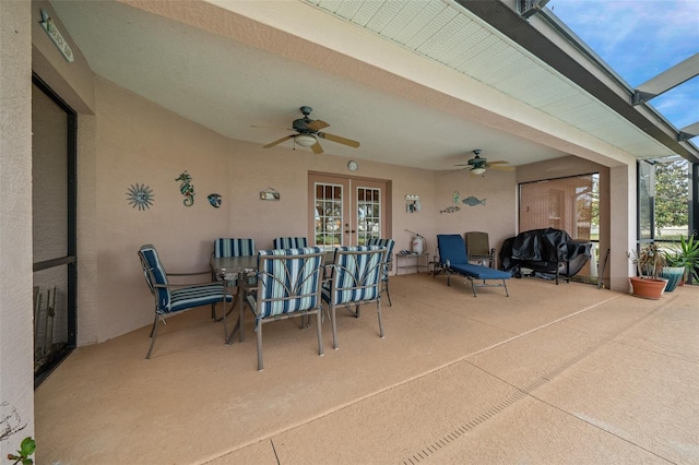 view of patio / terrace featuring glass enclosure, ceiling fan, and french doors