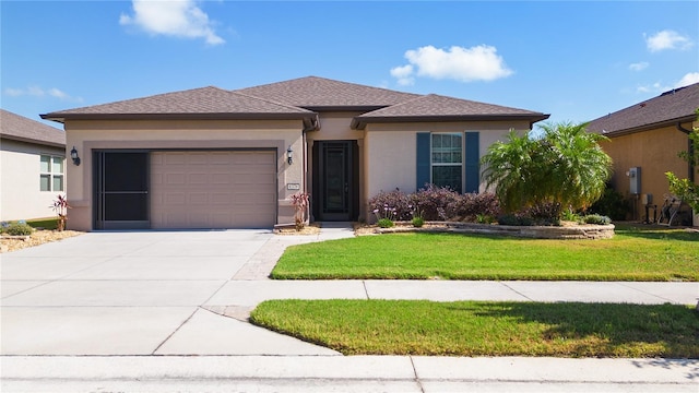 view of front of house with a front yard and a garage