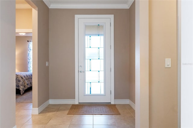 entryway with crown molding and light tile floors