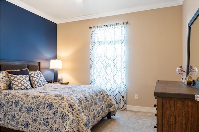 carpeted bedroom with ceiling fan and crown molding