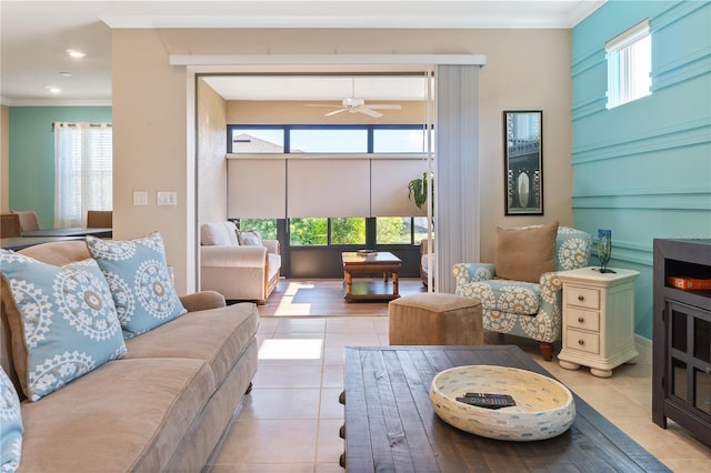 tiled living room with ceiling fan, a healthy amount of sunlight, and crown molding