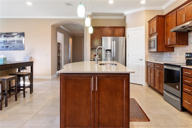 kitchen featuring a kitchen island with sink, decorative light fixtures, stainless steel appliances, light tile floors, and tasteful backsplash