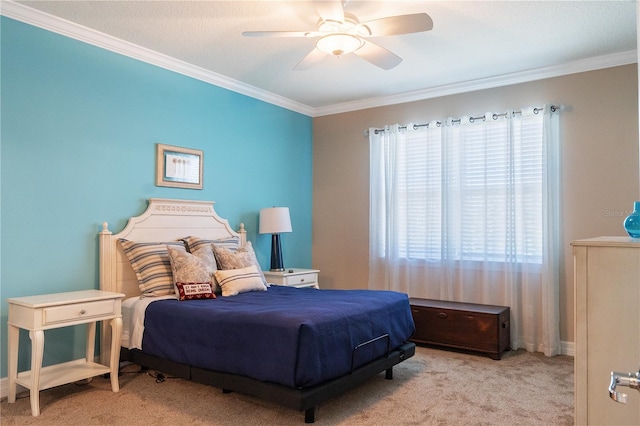 carpeted bedroom featuring ceiling fan and crown molding