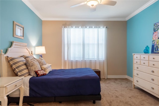 carpeted bedroom featuring ceiling fan and crown molding