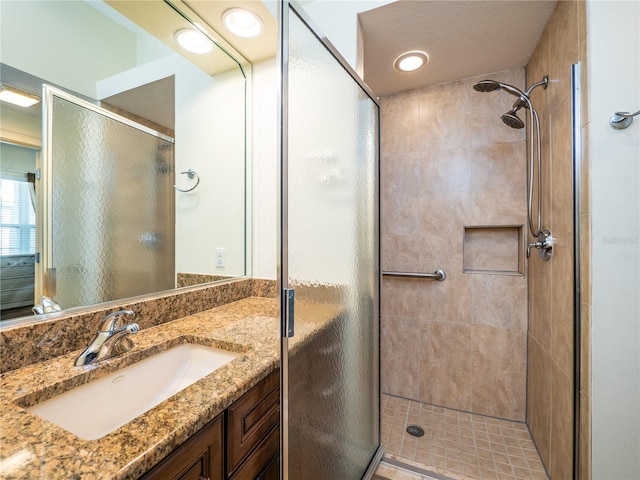 bathroom with vanity and a shower with shower door